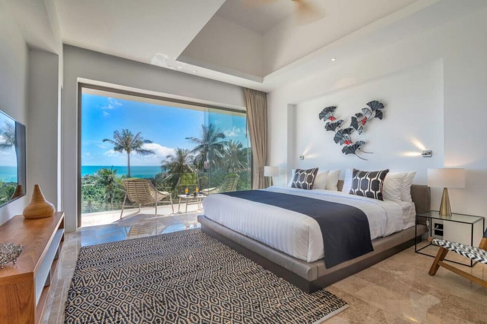 `Awake to serene views of palm trees and the ocean right from your bedroom.`