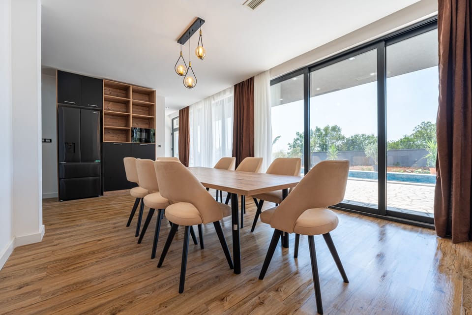 Dinning room is spacious, modern and dinning table can comfortably fit 8 people