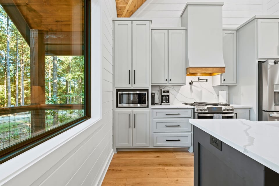 Enjoy cooking in this bright kitchen corner that boasts sleek cabinetry and built-in appliances