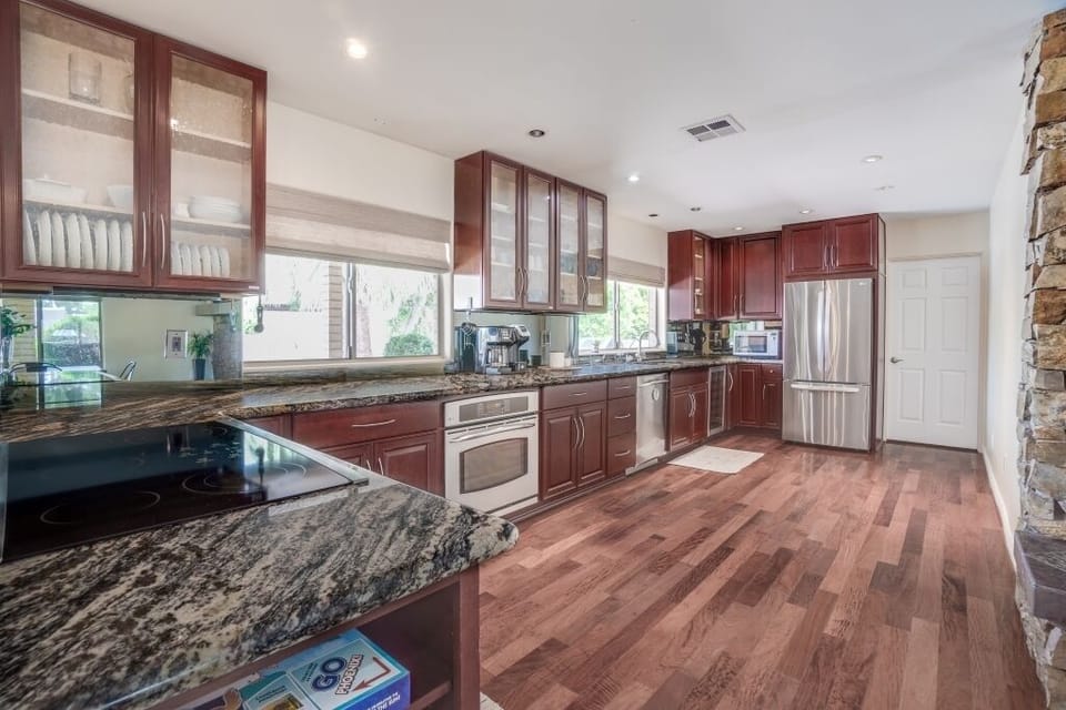 Expansive private kitchen with tableware, flatware, and appliances.