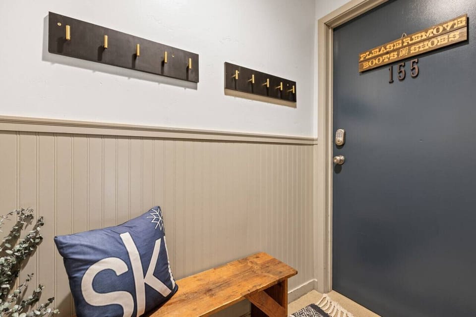 Bench area outside front door of condo -where you can sit and remove your boots.