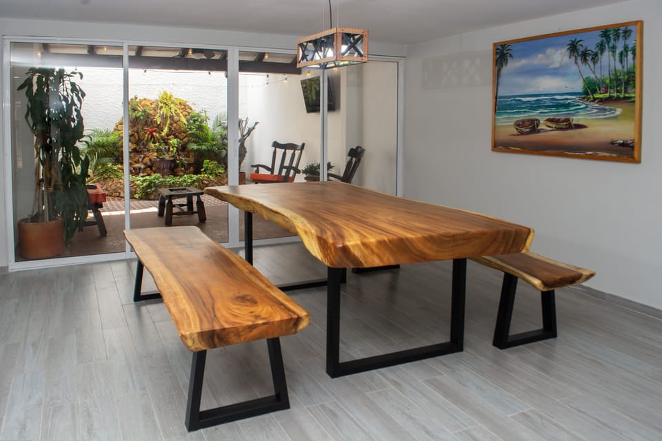 NEW EXOTIC WOOD DINING TABLE WITH SEATING FOR (12) GUESTS AND NEW A/C UNIT.