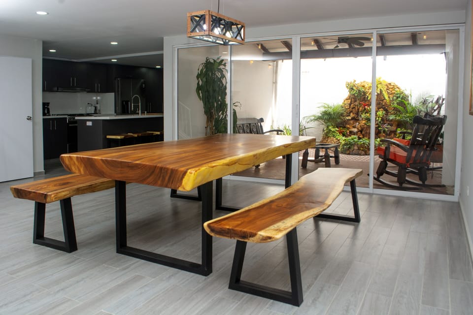 NEW EXOTIC WOOD DINING TABLE WITH SEATING FOR (12) GUESTS AND NEW A/C UNIT.