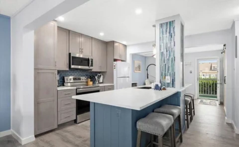 The kitchen has a large island with seating for 4 people.  