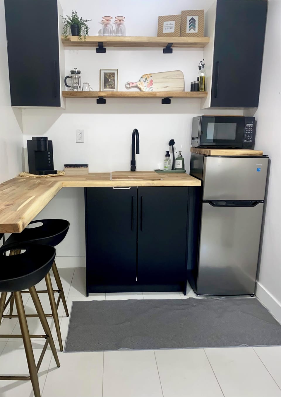 Kitchen with butcher block counter, seating for 2, microwave, coffee maker, etc