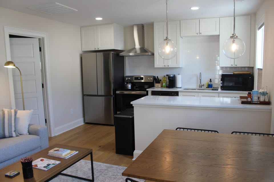 Kitchen view from the entry with full sized appliances, quartz countertops