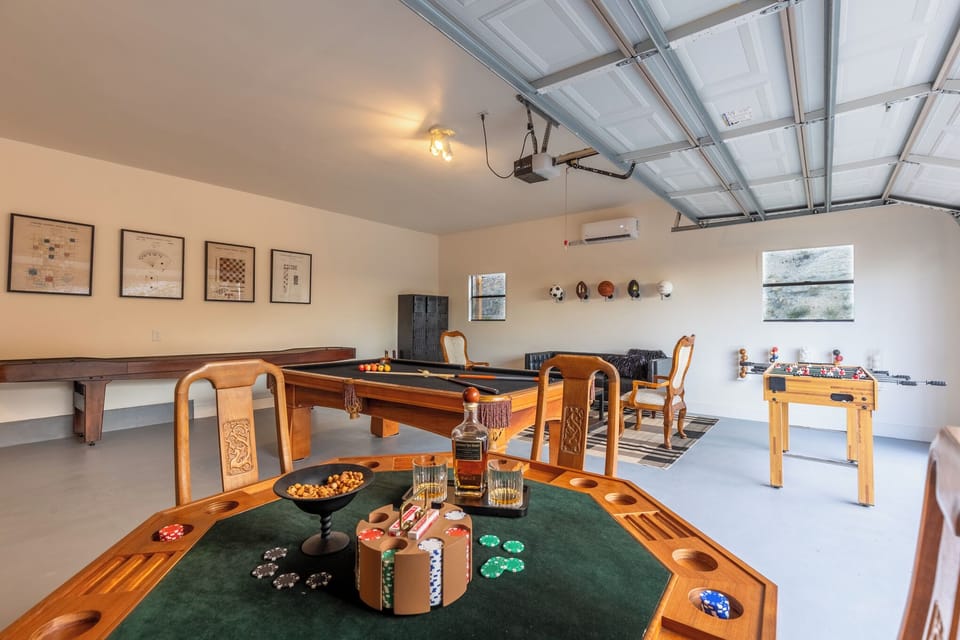 Game Room with antique poker table, 65in TV, shuffleboard, pool table, and more!