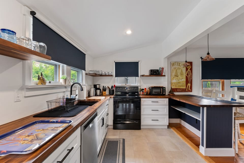 Spacious kitchen with long countertops, stainless appliances, and window views