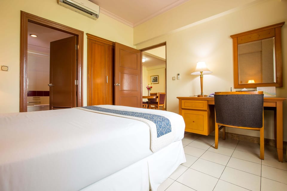 Desk, iron/ironing board, bed sheets