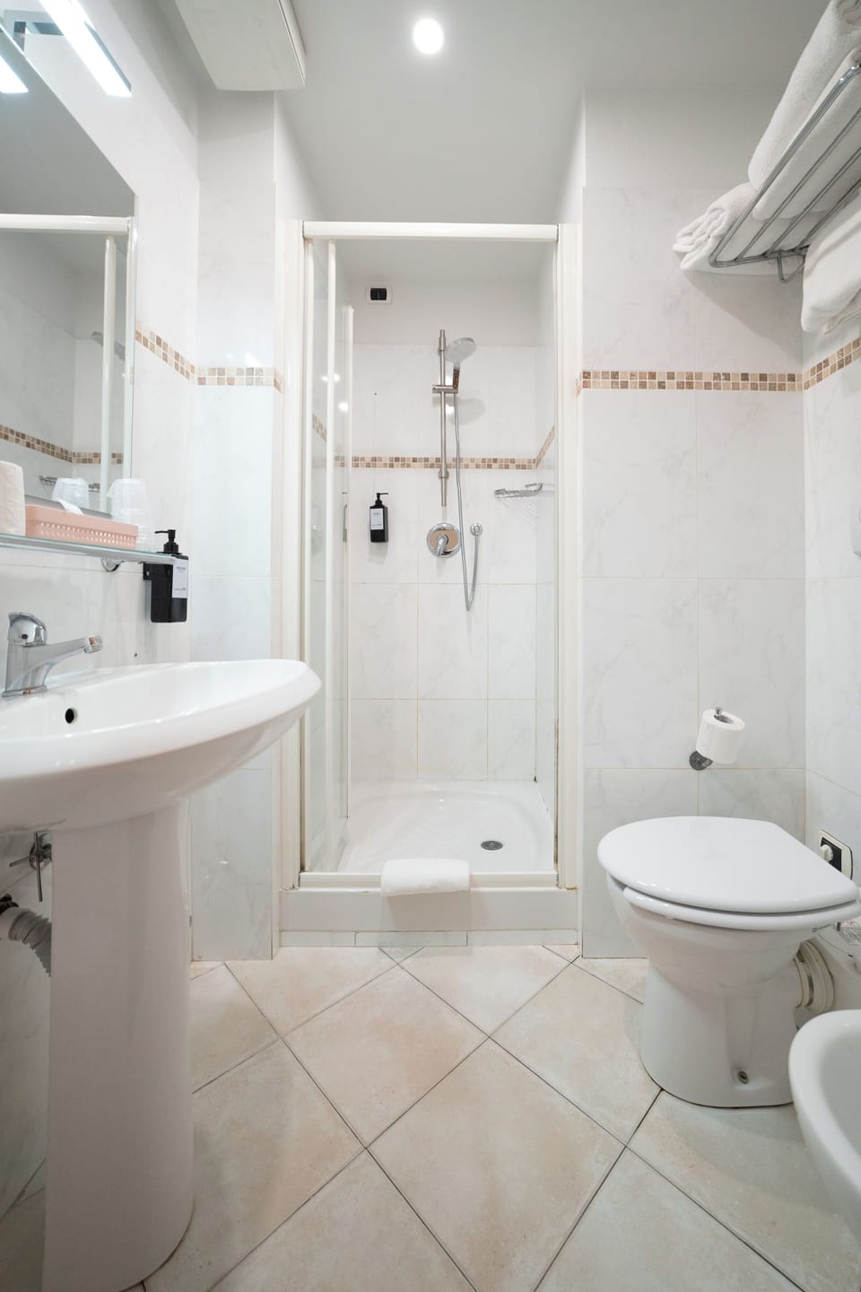 Shower, rainfall showerhead, designer toiletries, hair dryer