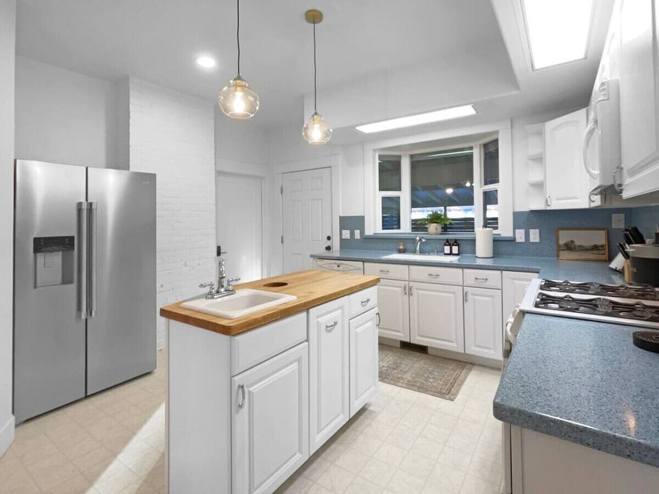 Large newly remodeled kitchen with new appliances and a center island.