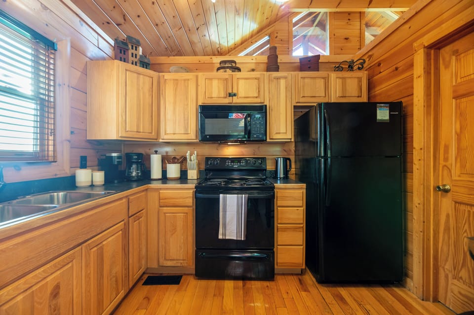 The kitchen is stocked with dishes, utensils, and cookware.