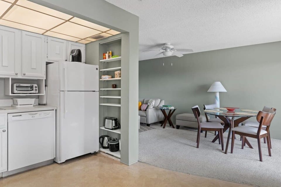 The dining table is conveniently located next to the kitchen