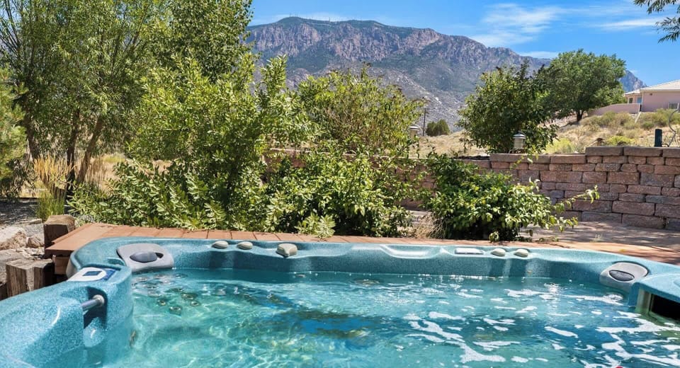 Enjoy breathtaking mountain views as you unwind in the outdoor jacuzzi