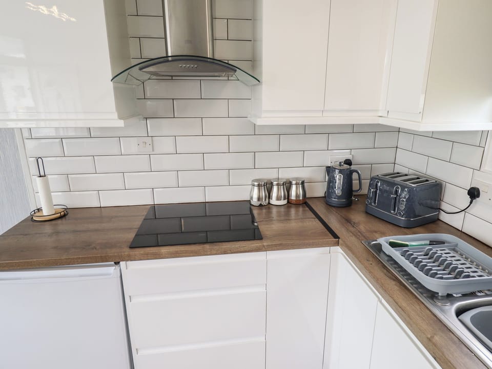 Fridge, electric kettle, cookware/dishes/utensils