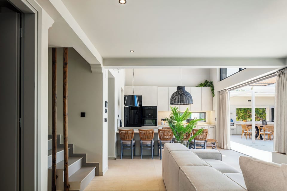 Adjacent to the living area is a stylish dining table that comfortably accommodates up to eight guests.