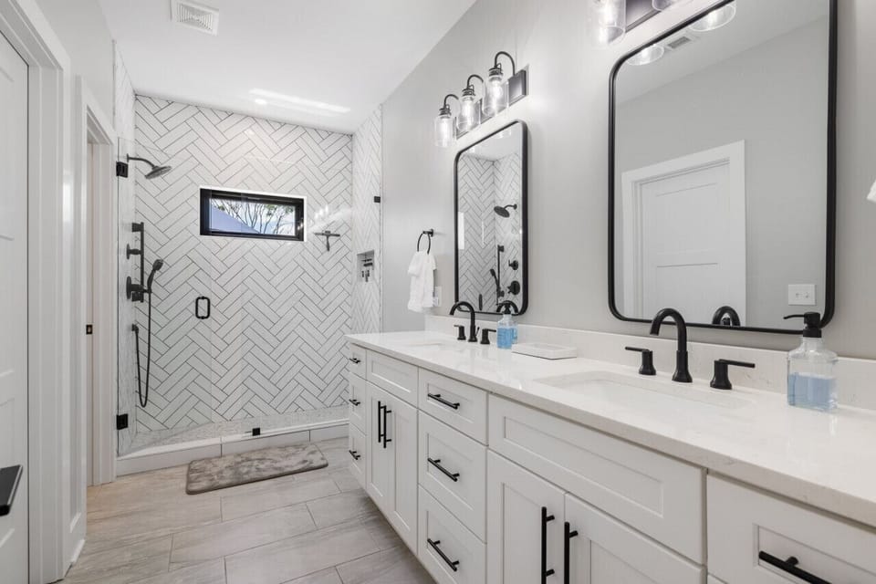 Master bathroom with dual sinks and full shower