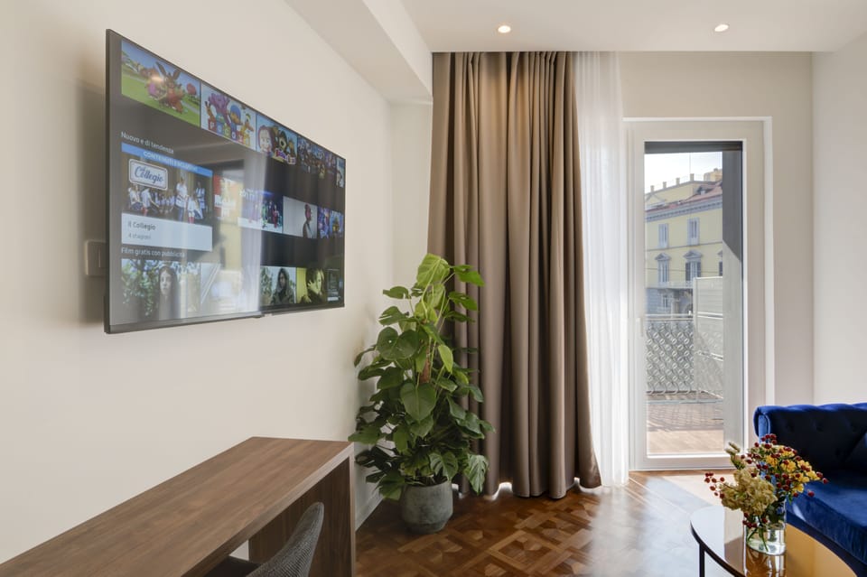 Luxury Suite | Living area | 50-inch LED TV with satellite channels