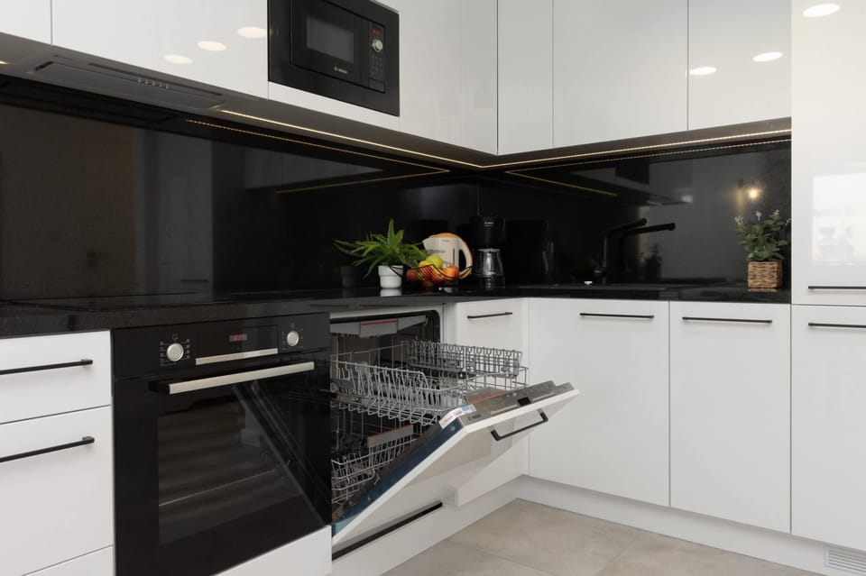 A closer look at the kitchen featuring a dishwasher and a clean, functional layout.

