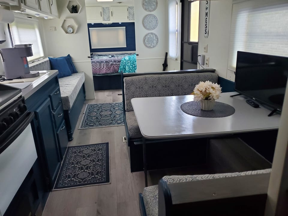 Booth seating & couch convert to twin beds.  Linens and blankets under queen bed