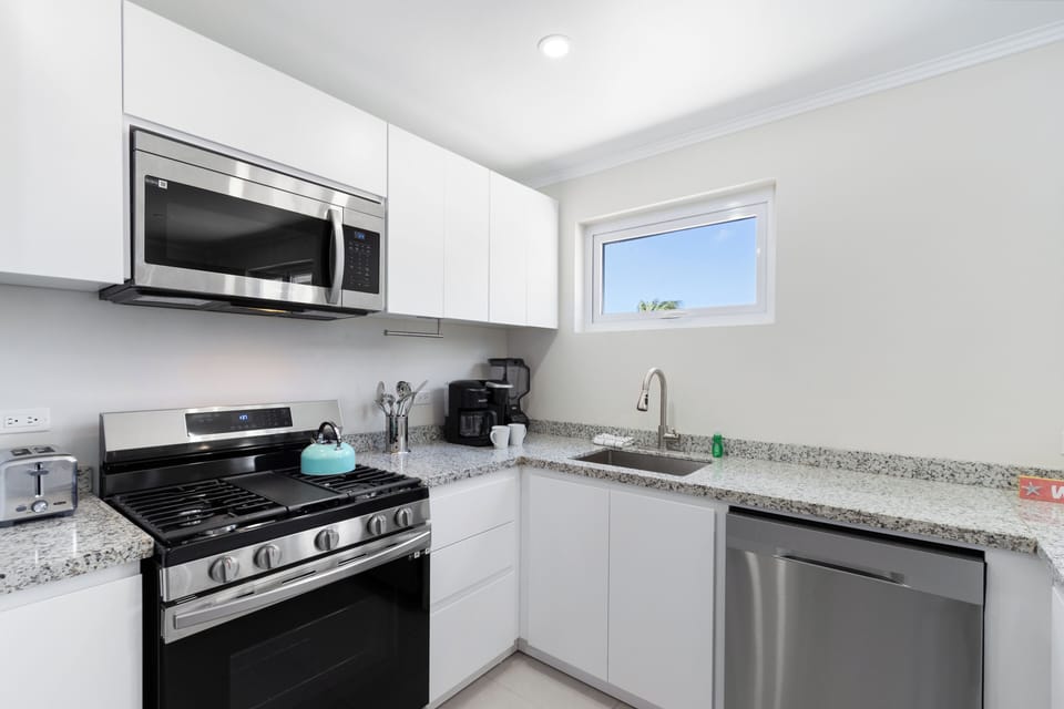 Lush Kitchen of the 2-BR Condo in Noord Aruba - Fully equipped kitchen - Modern kitchen with sleek, stainless steel appliances - Well-lit workspace with strategically placed task lighting