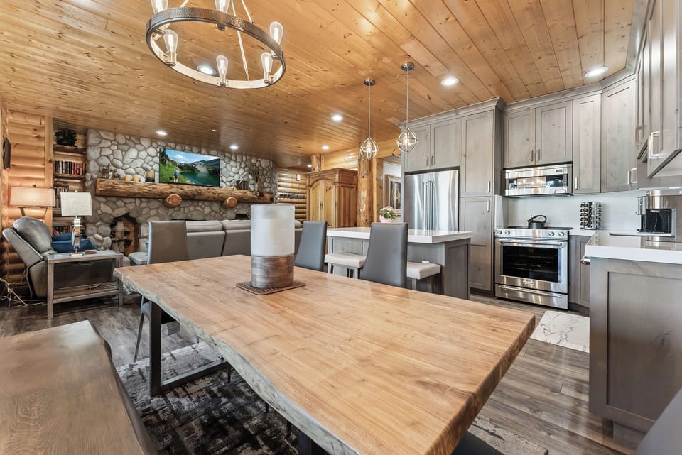 - Dining area with live edge table and modern lighting  
- Open layout connecting to kitchen and living room  
- Ideal for group meals and cozy mountain experiences