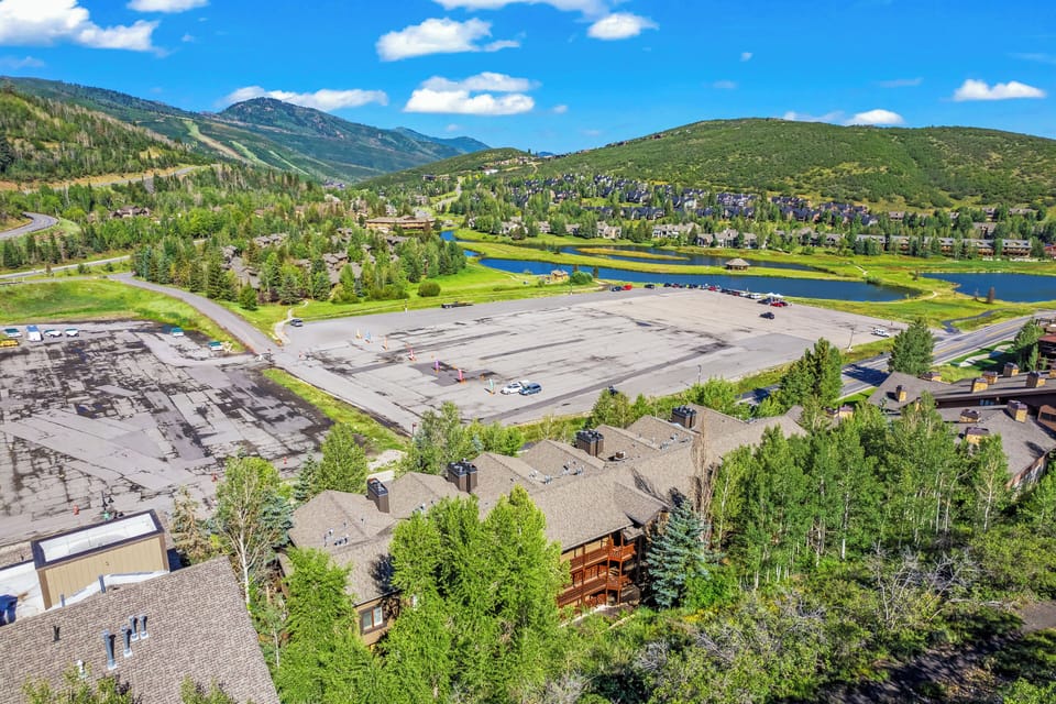 - Scenic aerial with lodge, parking and nearby mountain lake  
- Green mountain surroundings offer peaceful retreat vibes  
- Ideal location close to skiing, hiking and outdoor fun