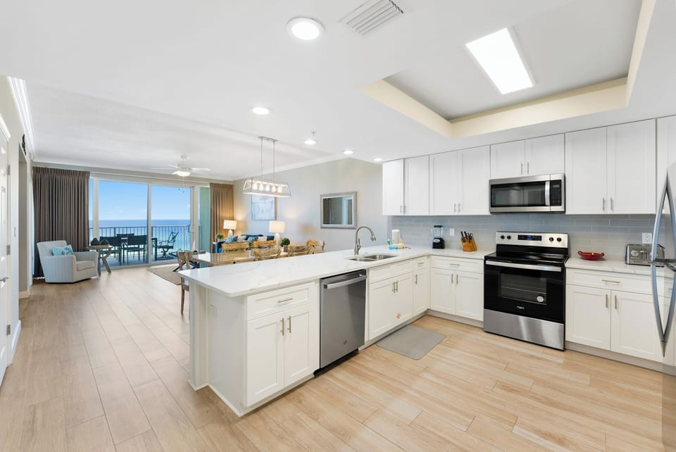 Your modern kitchen flows seamlessly into the living area, where stunning ocean views await through floor-to-ceiling windows.