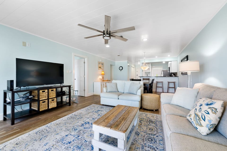 Relax in your spacious living area with comfortable seating, smart TV entertainment, and an open kitchen perfect for vacation cooking.