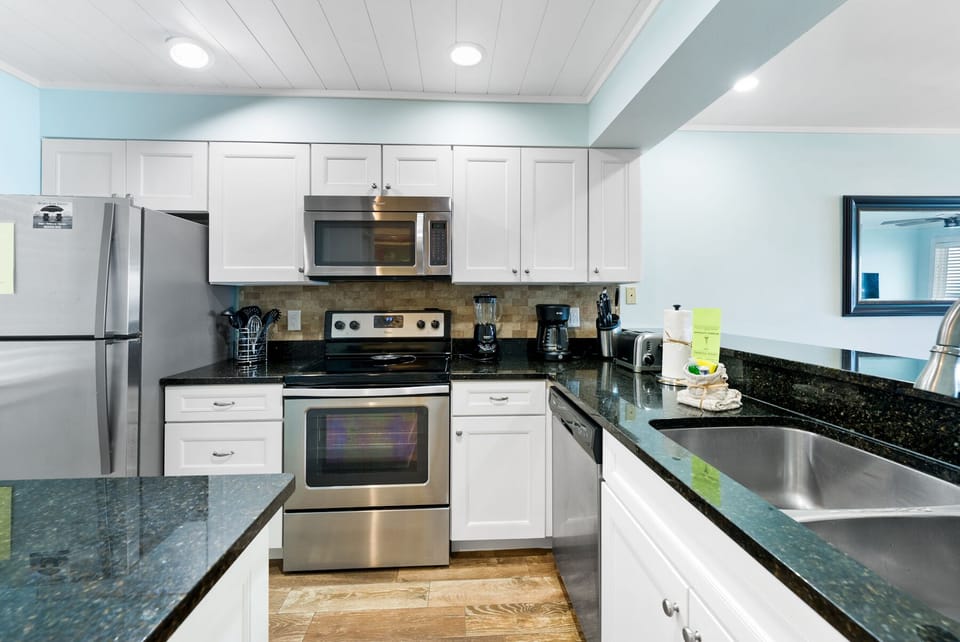 Your fully-equipped kitchen awaits with granite countertops, stainless appliances, and everything you need to create delicious meals during your stay.