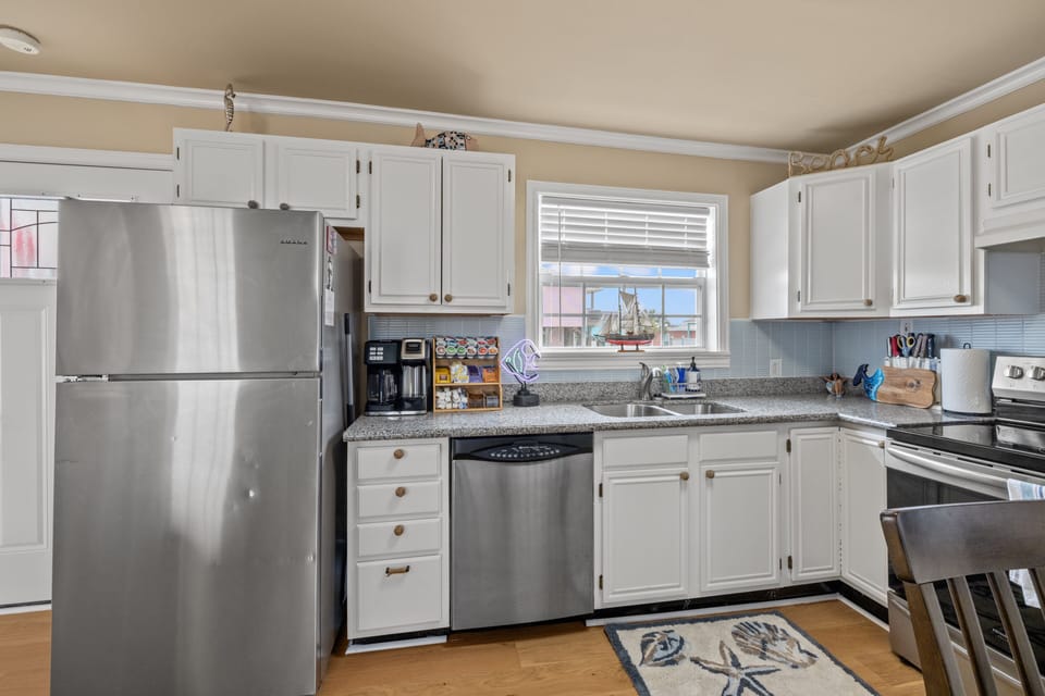 Full kitchen with fridge, freezer, and coffee bar.