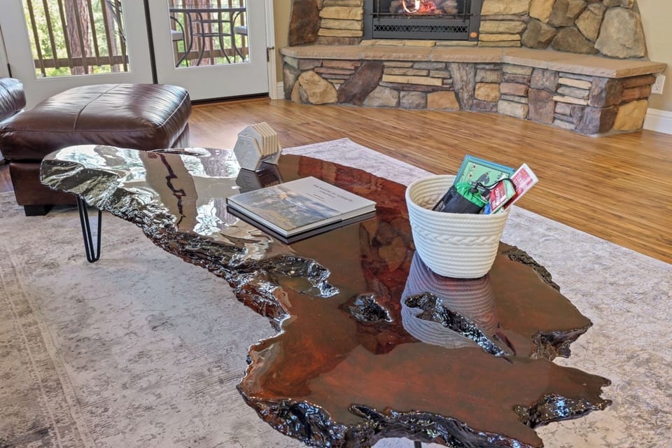 Living room w/ 65" smart tv, propane fireplace, leather sofa, chair, surround so