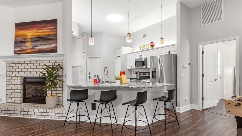Cook, connect, and create memories in the fully equipped kitchen, complete with sleek bar seating for casual dining, morning coffee, or evening chats while meals are prepared.