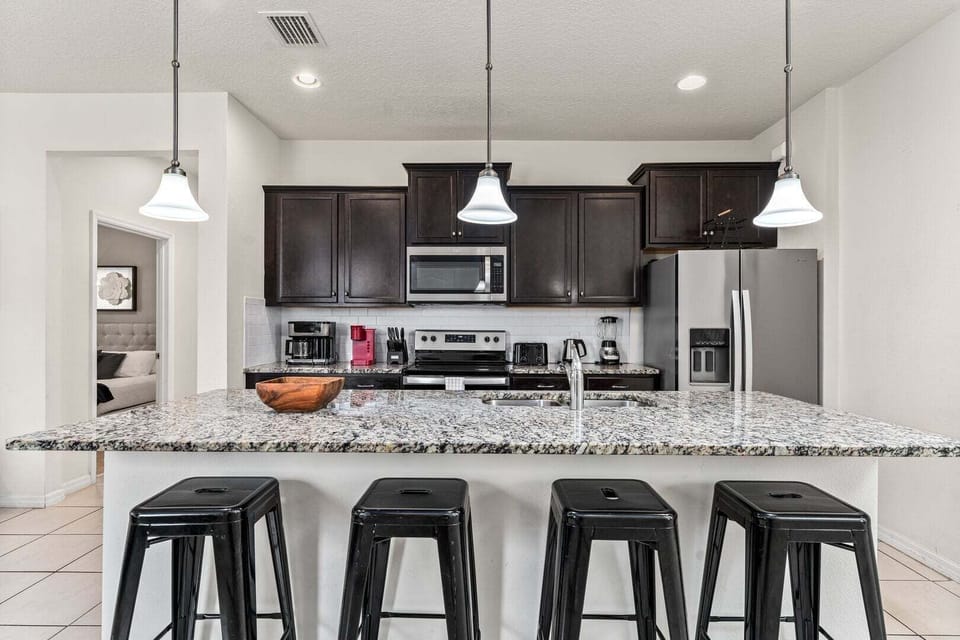 The fully equipped kitchen features stainless steel appliances.