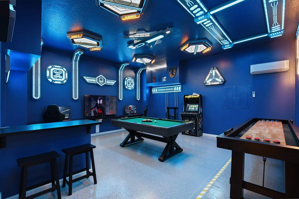 Futuristic gaming lounge with arcade, pool, shuffleboard, and LED sci-fi decor.