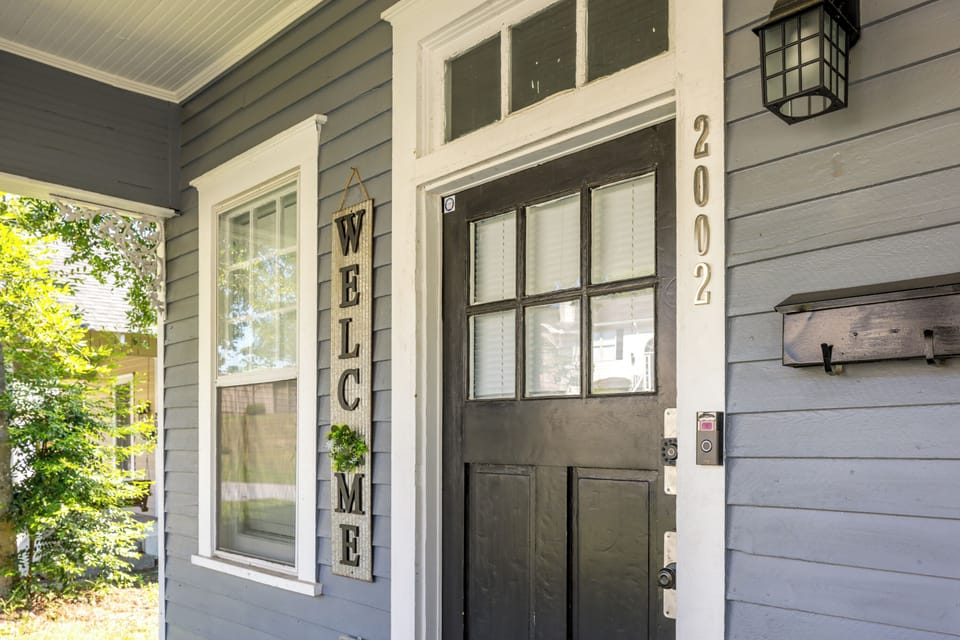 Inviting entryway featuring a classic wooden door with vintage details. 
