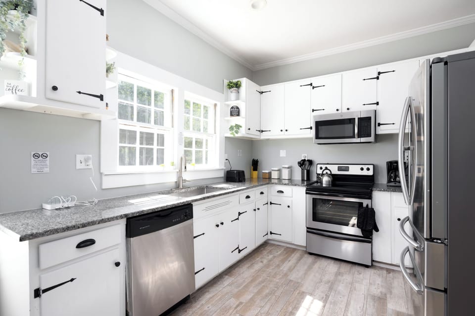 Bright kitchen featuring a large window overlooking the spacious backyard