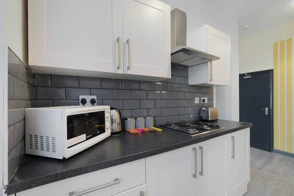 Kitchen equipped with all essentials, including a washer & dryer, oven, fridge and full cookware set.