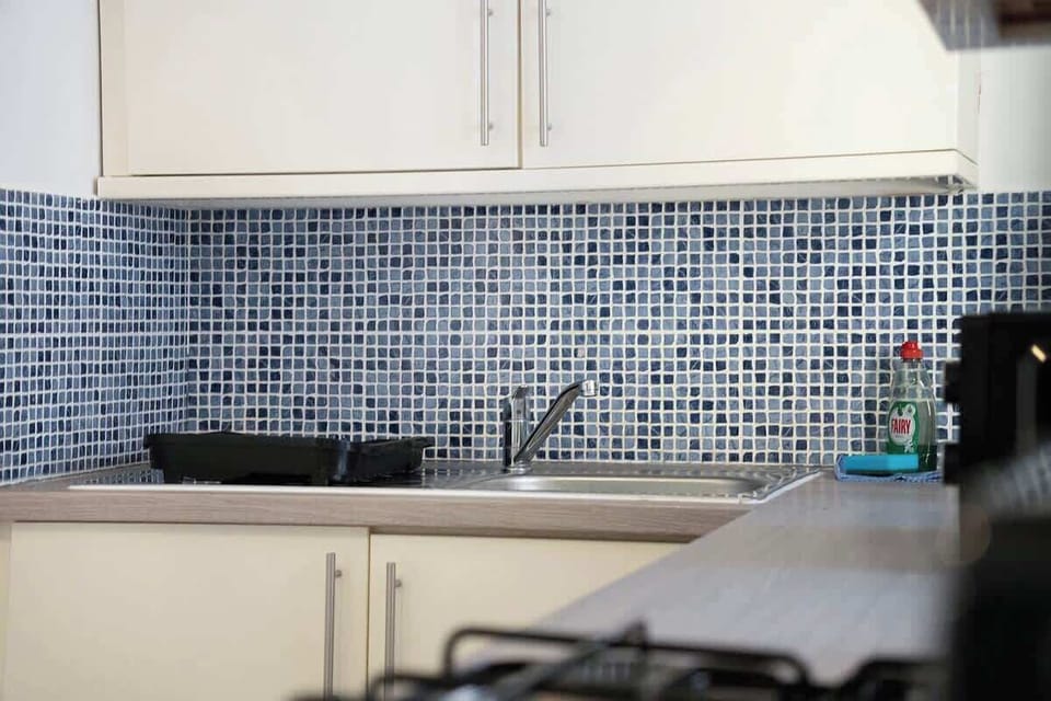 Kitchen equipped with all essentials, including a washer & dryer, oven, fridge and full cookware set.