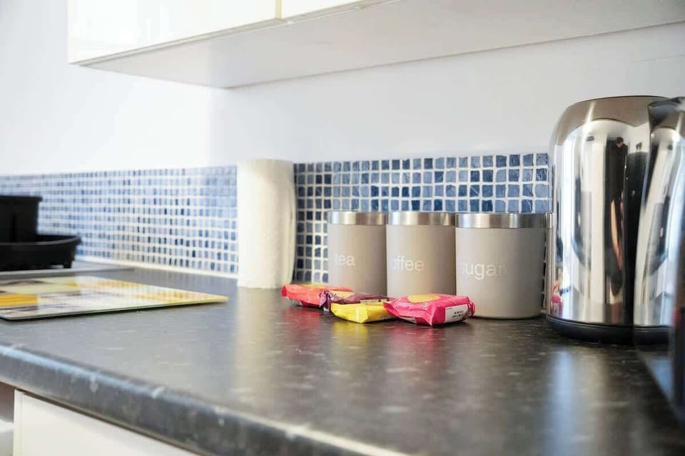 Kitchen equipped with all essentials, including a washer & dryer, oven, fridge and full cookware set.
