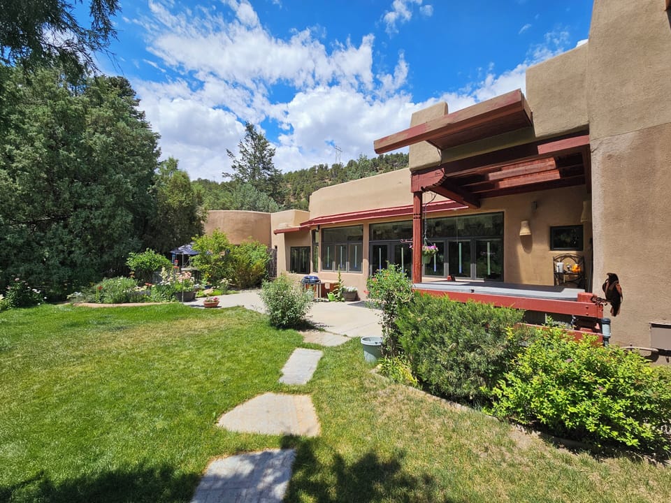 This rear view of the home enjoys blossoming flowers for most the the spring, summer and fall months months