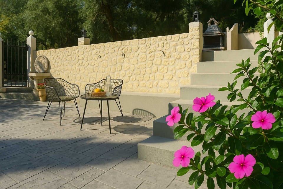 Enjoy a Drink or a Meal from the Outdoor Terrace Framed by Stone Walls and Flowers
