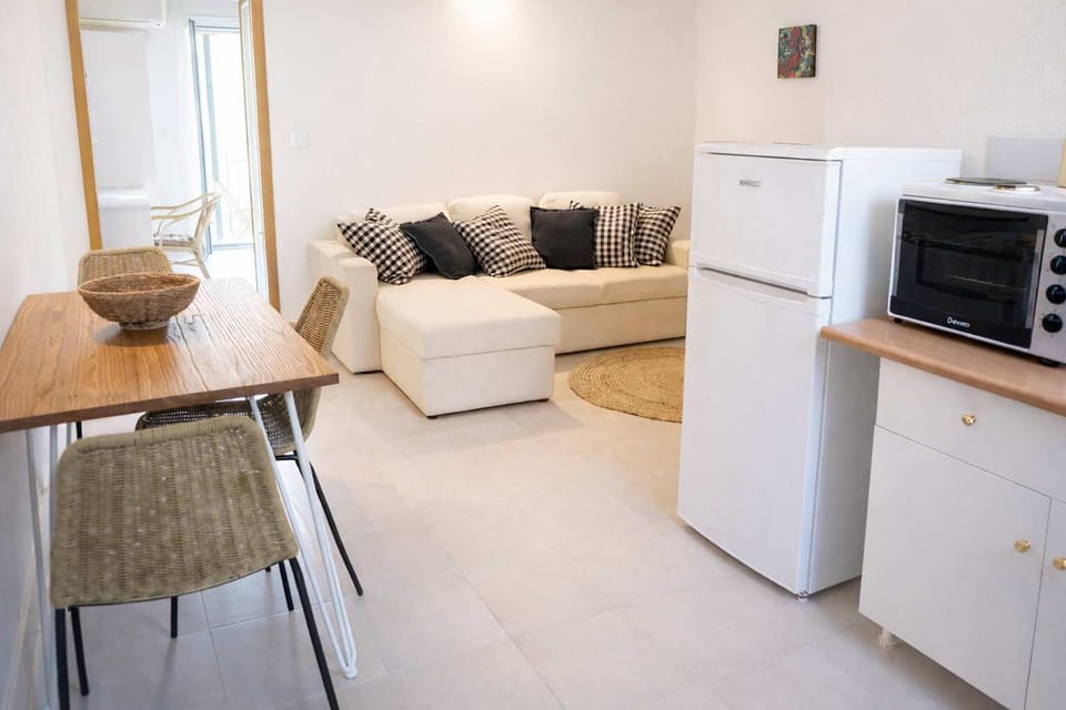Additional Kitchenette Area with Sofa and Dining Setup for Practical Convenience