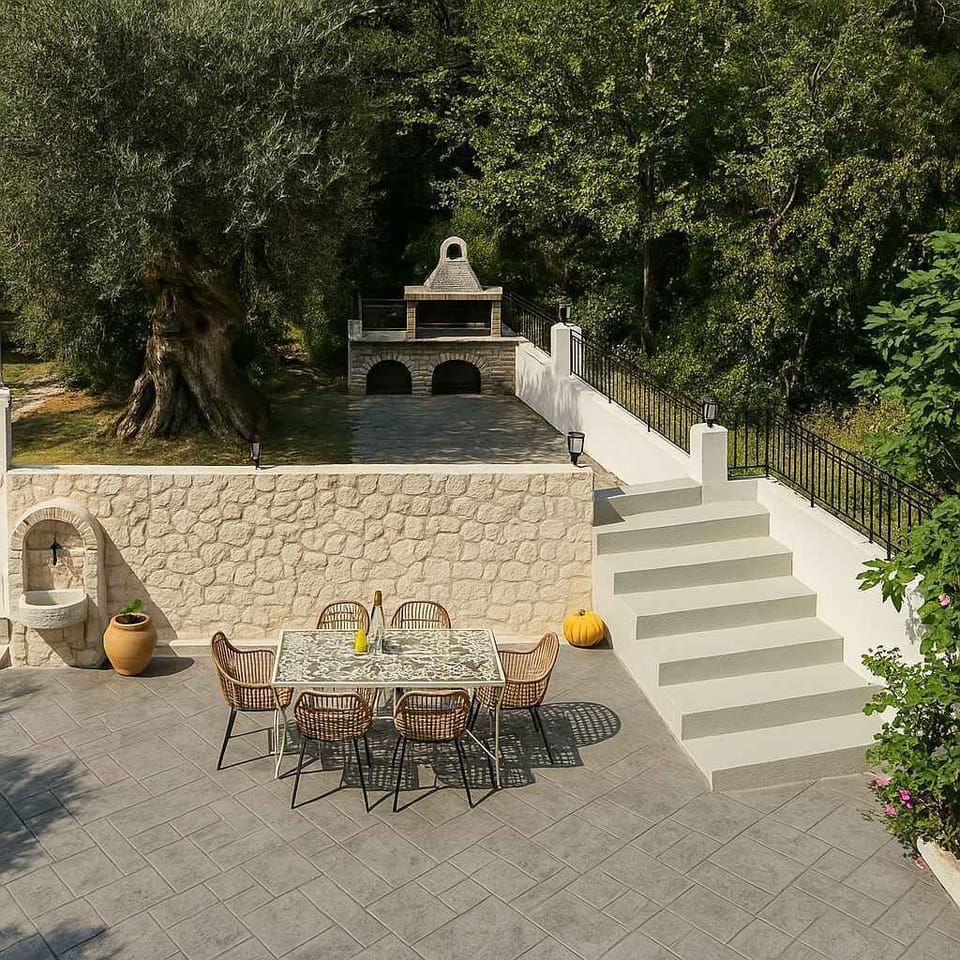 Traditional Outdoor BBQ Area Surrounded by Stonework and Greenery