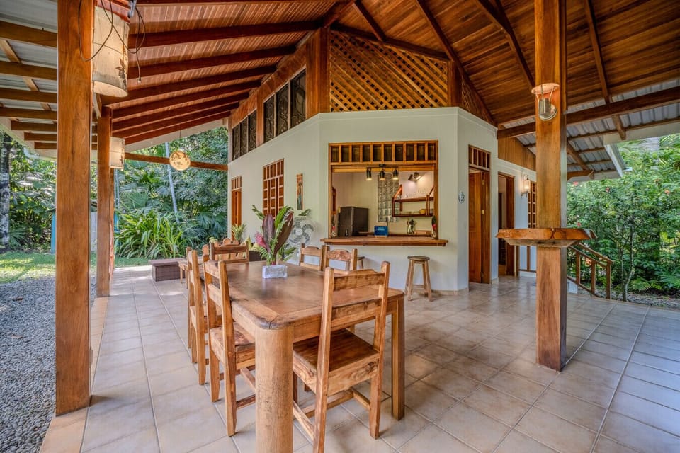 Spacious open-air living and dining area at Osos Caribeños in Playa Chiquita