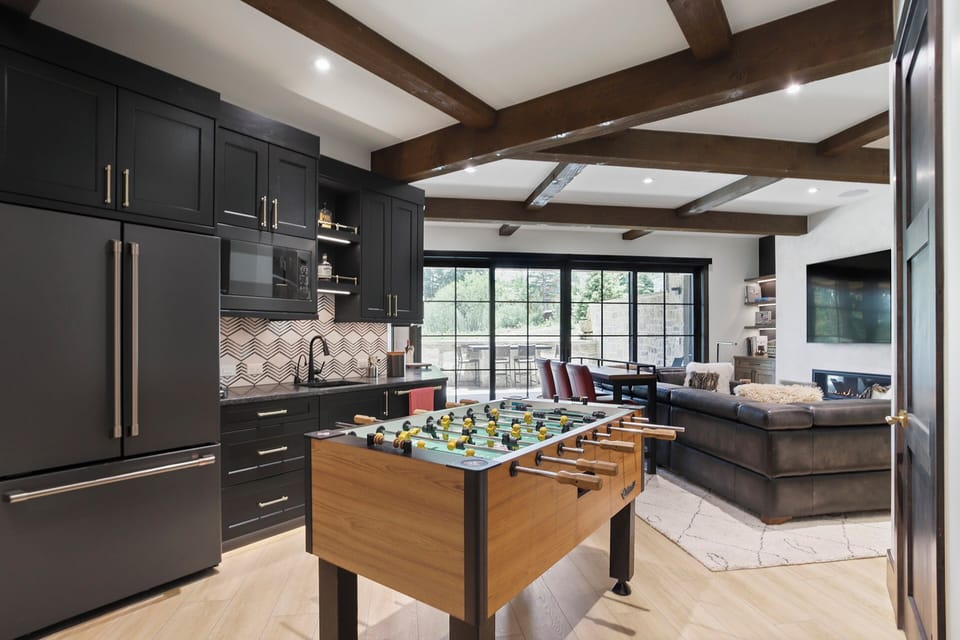 Lower level rec room with foosball table, kitchen and wet bar