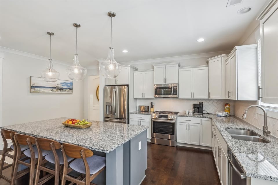 Gourmet kitchen with stainless appliances and granite countertops.