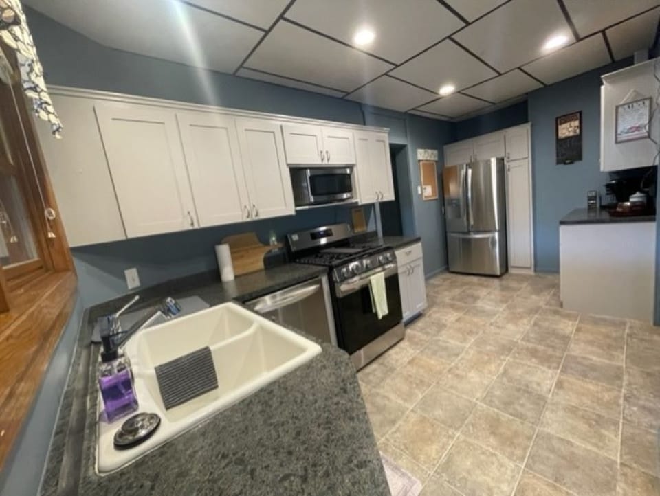Kitchen with updated appliances for a modern and convenient cooking space.