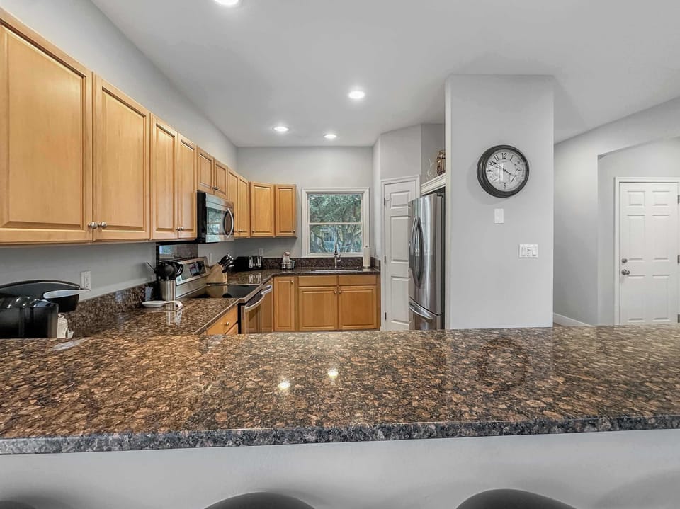 Main Level: Spacious Kitchen w/ Granite Countertops, Stainless Steel Appliances, Ample Cabinet Storage, and Recessed Lighting