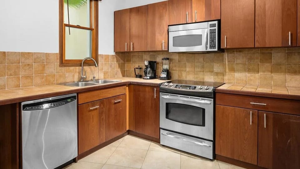 Kitchen is equipped with stainless-steel appliances and cooking basic.